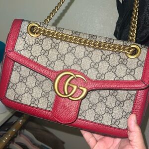 .beautiful red and canvas purse with adjustable straps.